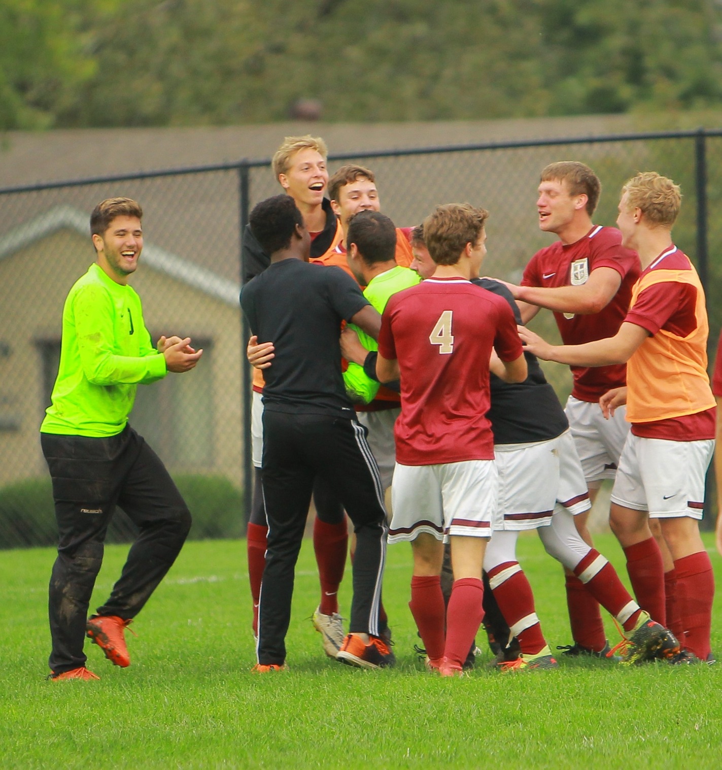 Eagles players mob goalkeeper Daniel Moore following an incredible penalty kick save, ending the game in a 0-0 tie against #10 Emmaus.